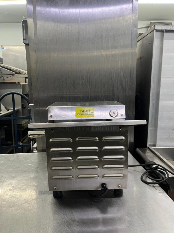 SOMERSET CDR-100 10" countertop one stage dough sheeter, 120V, 1/4 HP. Stainless steel, good condition. Warning label visible.