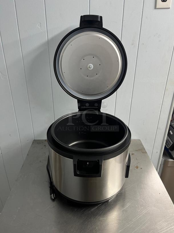 Brand new COOKRITE SRC-60H rice cooker/warmer, 120V, with rice paddle holder, stainless steel finish, open lid view.