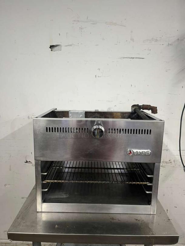 JADE RANGE JCM-24 gas cheesemelter, wall-mounted, infrared burners, 20000 BTU, stainless steel, JADE logo visible.