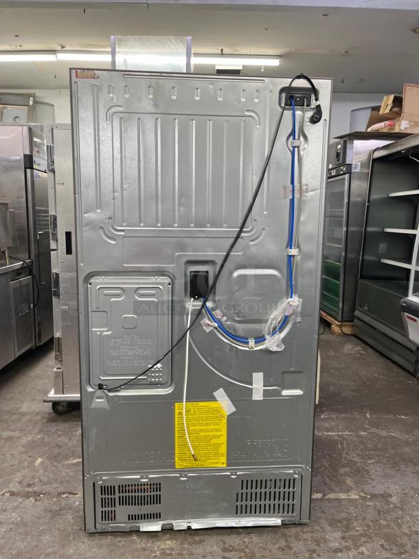 Brand new Samsung 36" French Door Refrigerator RF28R7201SR, open box condition, silver finish, rear view with cord.