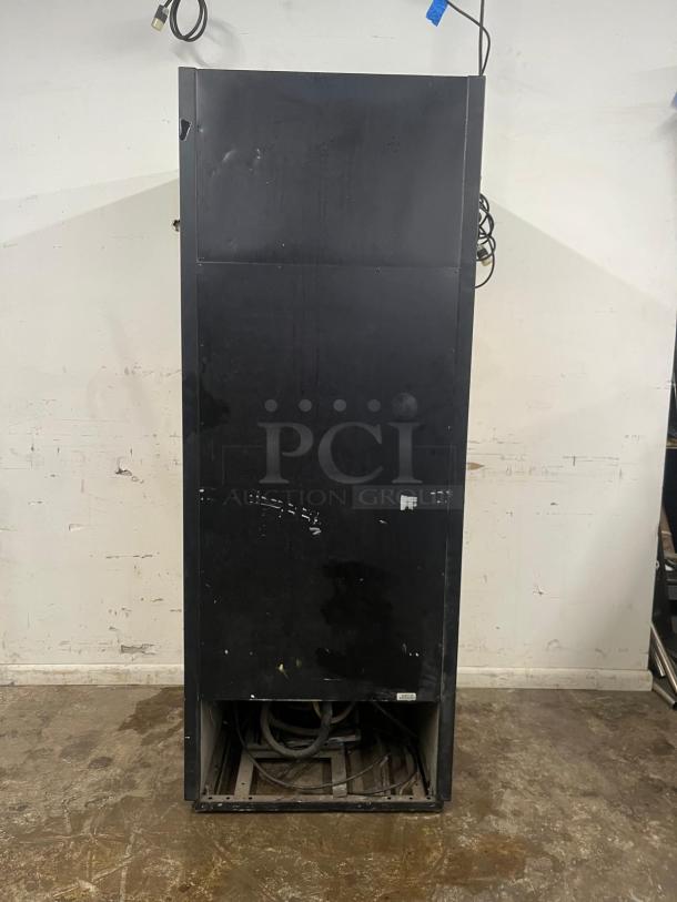 TRUE GDM-26 30" Merchandiser Refrigerator, black with visible wear, back view showing power cord.