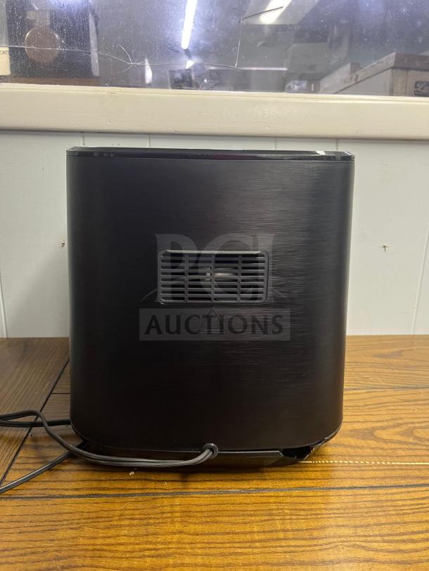 Insignia 5 Qt. Digital Air Fryer, Stainless Steel back view. Power cord attached, rear vent and warning symbol visible.