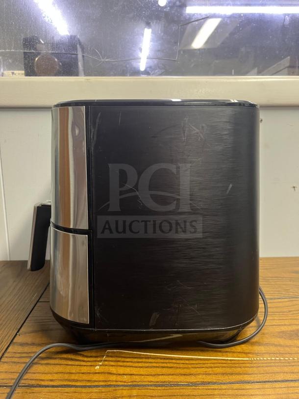 Insignia™ 5 Qt. Digital Air Fryer in stainless steel, used condition, with visible surface scratches on the exterior.