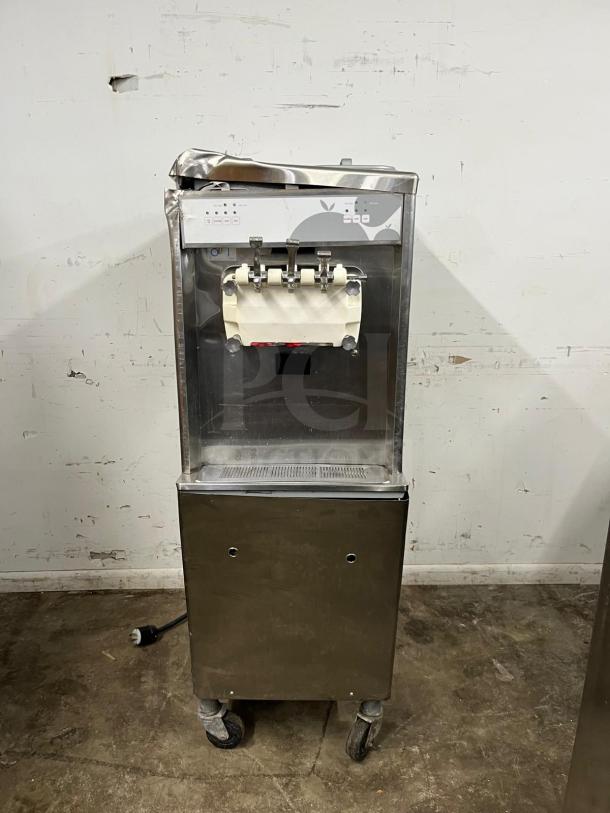 TAYLOR 794-33 soft serve ice cream machine, stainless steel, on wheels, visible wear. Dual dispensers, control panel.