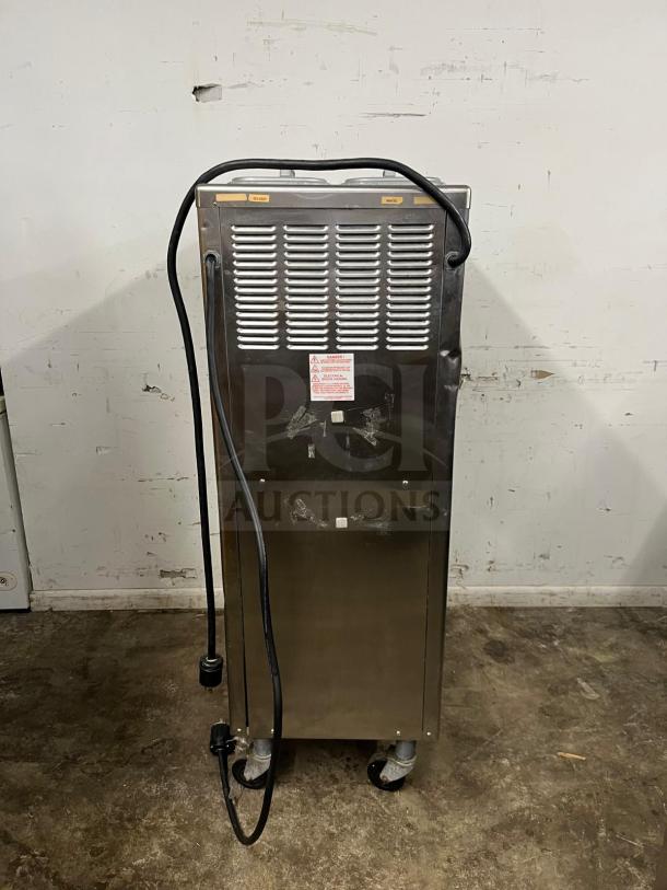 TAYLOR 794-33 soft serve ice cream machine. Stainless steel, upright unit with visible cords. Slight wear evident.