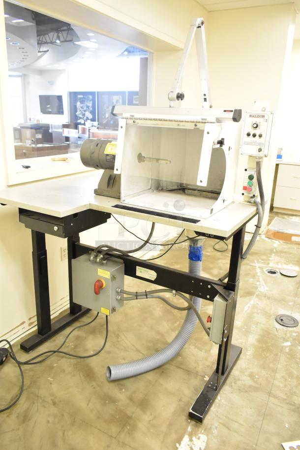 Baldor enclosed suction polishing machine with foot pedal, 208-230/460V, 3 phase, in excellent condition, control panel visible.