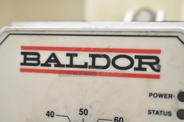 Baldor Enclosed Suction Polishing Machine label, showing brand name and control panel.