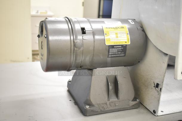 Baldor enclosed suction polishing machine with foot pedal, 208-230/460V, 3 phase, metallic body, visible label with specs.