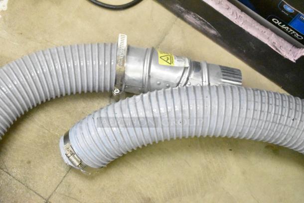 Quatro Air Technologies PGR-21 dust collector hoses, gray with metal clamps, showing part of the air purification system.