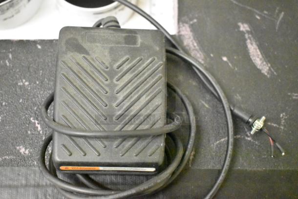 Quatro Air Technologies PGR-21 commercial dust collector pedal, shown with coiled cable. Slight wear visible.
