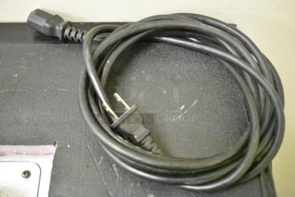 Quatro Air Technologies PGR-21 dust collector power cord, black, coiled on unit's surface. 100-120V, 1 Phase.