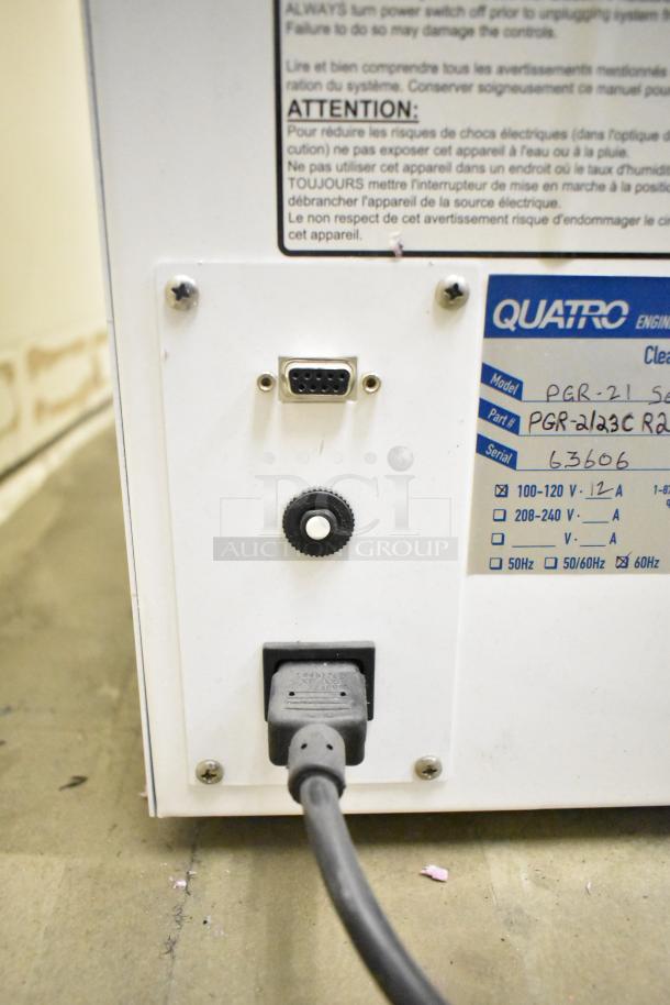 Quatro Air Technologies PGR-21 air purifier with visible connection ports and label showing voltage and model details.