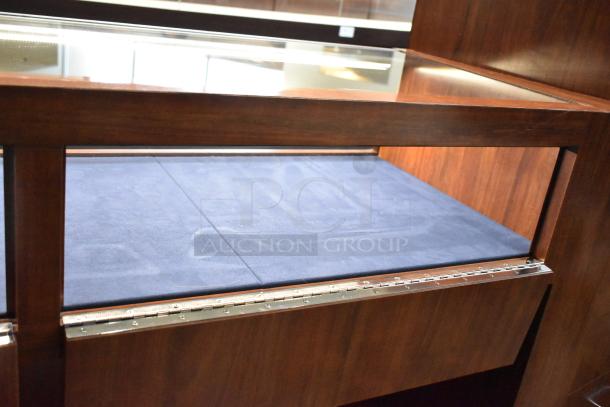 Wooden jewelry merchandising display case with glass top, dark finish, blue-lined interior, metal hinge. Excellent condition.