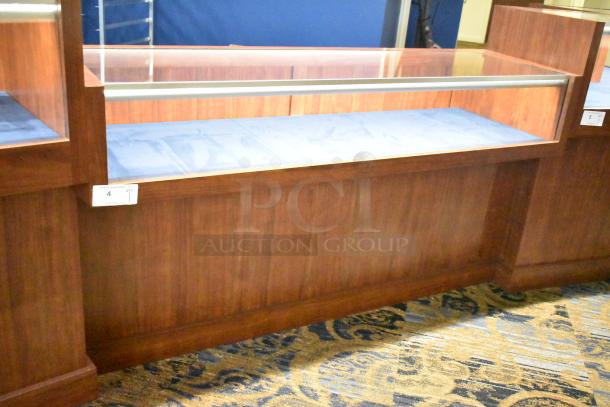 Wooden jewelry merchandising display case with glass top, blue velvet interior, and a visible product tag marked "4 QTY 1".