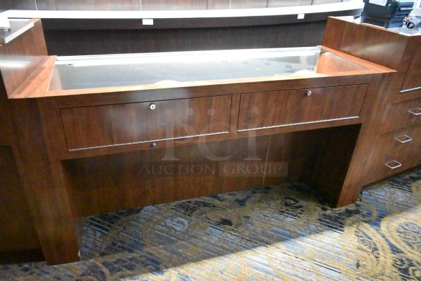 Wooden jewelry merchandising display case with glass top, dual lockable drawers, and rich wood finish. Suitable for retail use.