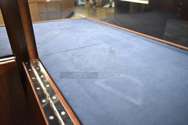 Wooden corner jewelry display case, glass panels, blue velvet interior, metal hinge detailing, excellent condition.