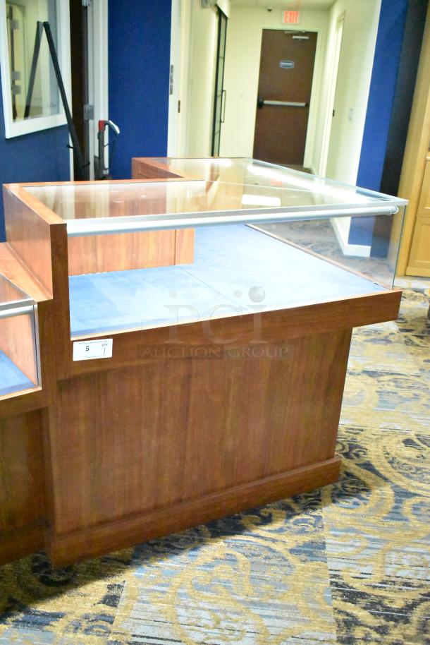 Wooden corner-style jewelry display case with glass top, blue interior, in excellent condition. Features a labeled compartment.
