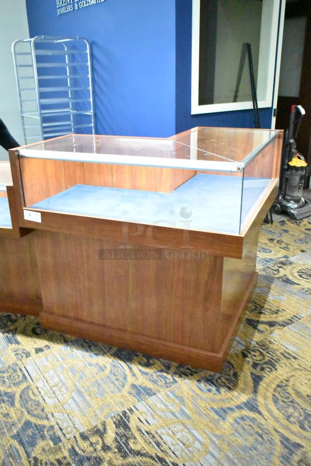 Wooden corner-style jewelry display case with glass top, blue interior. Ideal for retail merchandising.