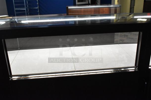 Wooden jewelry display case with glass top, modern design, excellent condition, ideal for showcasing items.