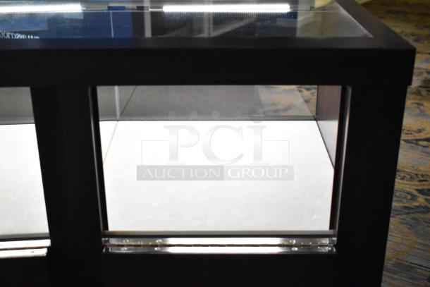 Wooden jewelry merchandising display case with glass panels and LED lighting, ideal for showcasing valuables.