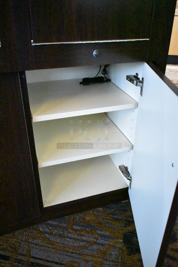 Wooden jewelry merchandising display case with open cabinet, featuring three white shelves and metal hardware, in good condition.