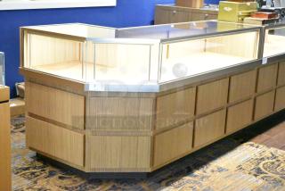 Wooden corner-style jewelry display case with glass top, sleek design, good condition, ideal for showcasing items.