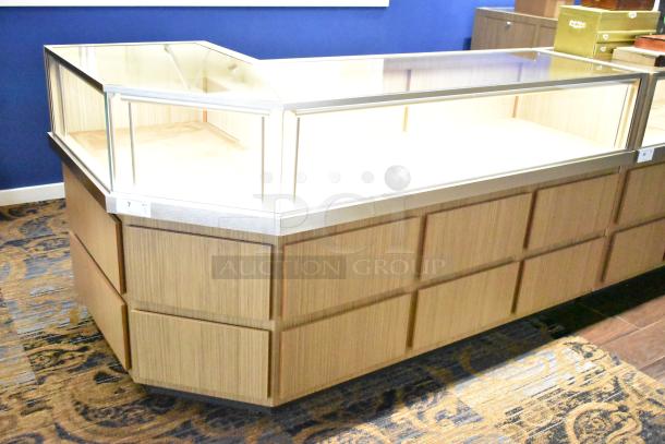 Wooden corner-style jewelry display case with glass top and metal trim, used condition, ideal for showcasing items.