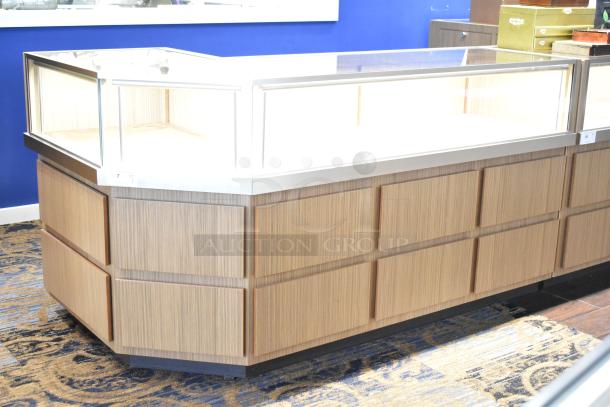 Wooden corner style jewelry merchandising display case with glass top; features light wood finish and sturdy construction.