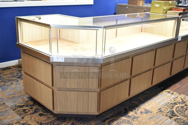 Wooden corner style jewelry merchandising display case with glass top, light wood finish, and metal trim. Excellent condition.