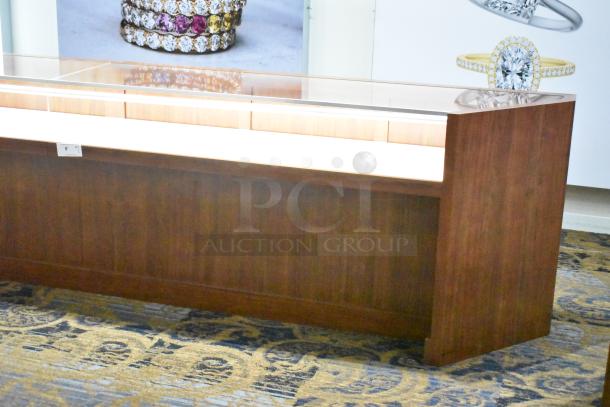 Wooden corner-style jewelry display case with two rear drawers, glass top, wood finish, excellent condition.