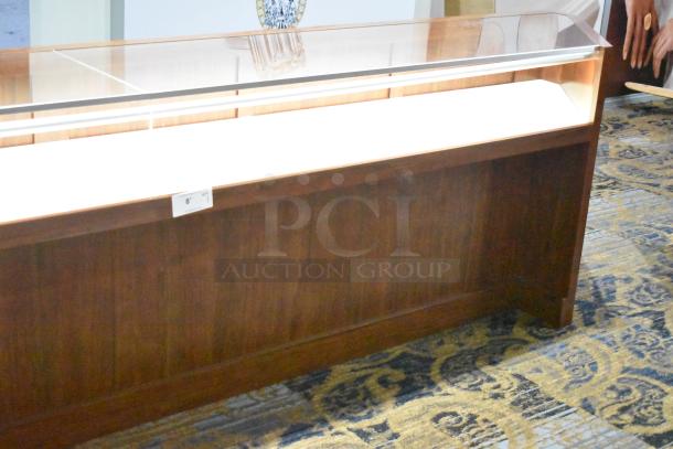 Wooden corner jewelry display case with glass top, two rear drawers, and a label indicating "8' 1"."