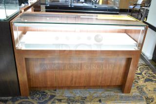Wooden corner jewelry display case with glass top, two rear sliding doors, in excellent condition.