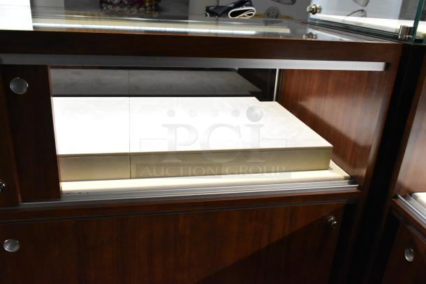 Wooden corner jewelry display case with glass top, 2 rear sliding doors, and elegant dark finish. Ideal for retail use.