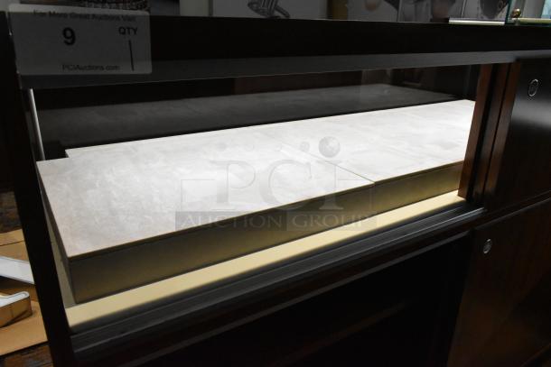 Wooden corner-style jewelry display case with two rear sliding doors, ideal for merchandising. In used condition.