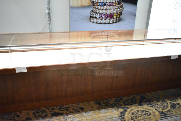 Lighted wooden jewelry display case with glass top, two drawers, and visible tag indicating item number 14.