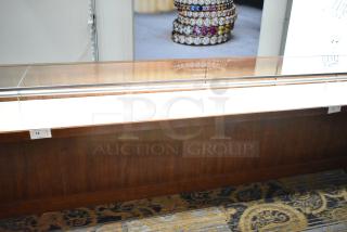 Lighted wooden jewelry display case with glass top, two drawers, and visible tag indicating item number 14.