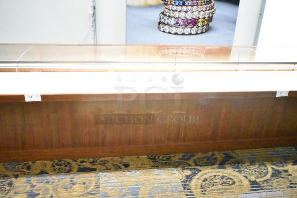 Lighted wooden jewelry display case with two drawers, glass top, and modern finish. Ideal for showcasing fine jewelry.