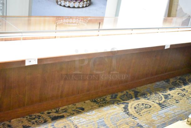 Lighted wooden jewelry merchandising display case with glass top and two drawers, excellent condition, item tag visible.