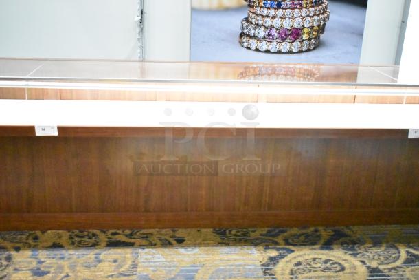 Lighted wooden jewelry display case with glass top, two drawers, and visible number tags. Excellent condition.