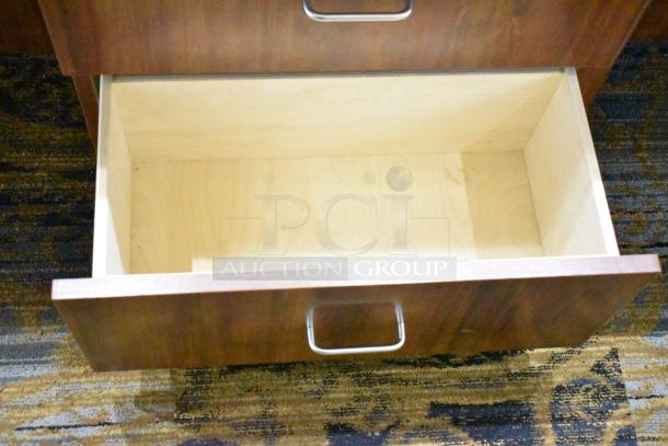 Lighted wooden jewelry display case with two drawers, features sleek metal handles and spacious interior, in good condition.