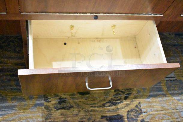 Lighted wooden jewelry merchandising display case with open drawer, metal handle, and visible interior hooks.