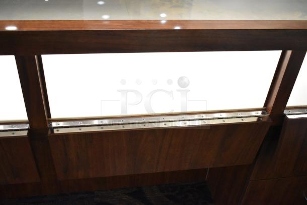 Lighted wooden jewelry display case with glass top, two drawers, and metal hinges. Excellent condition.