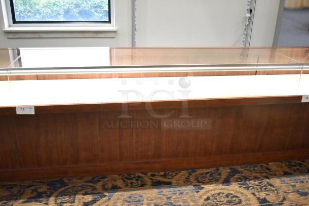 Lighted wooden jewelry display case with glass top, two drawers, cherry finish, excellent condition, tags show item number 15.