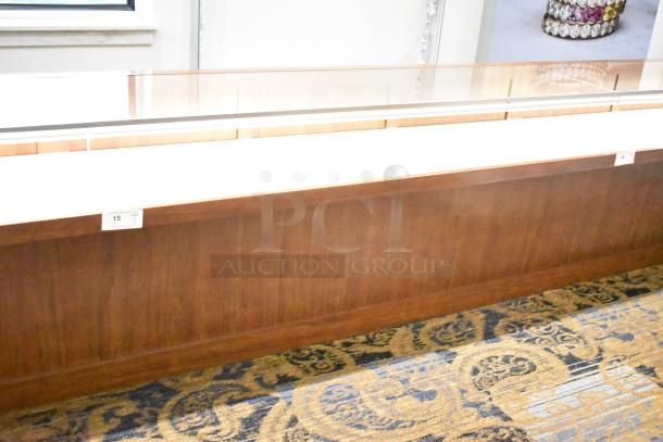 Lighted wooden jewelry display case with 2 drawers, glass top, excellent condition. Ideal for showcasing items.