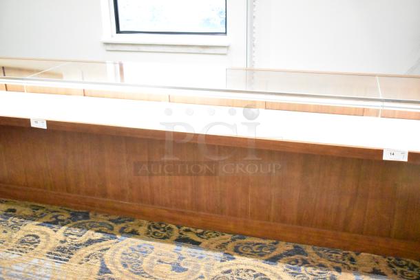 Lighted wooden jewelry display case with two drawers, glass top, and lighting; excellent condition, ideal for showcasing items.