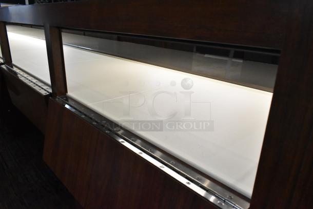 Lighted wooden jewelry merchandising display case with two drawers, glass top, excellent condition, dark wood finish.