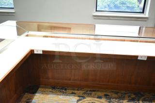 Lighted wooden jewelry display case with glass top, pristine condition, item tags labeled 15 and 16 visible.