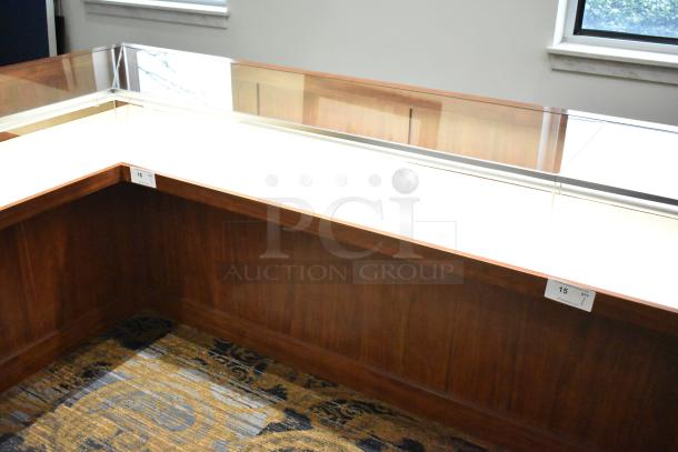 Lighted wooden jewelry display case with glass top, excellent condition, corner design, visible tags indicate quantity and measurements.