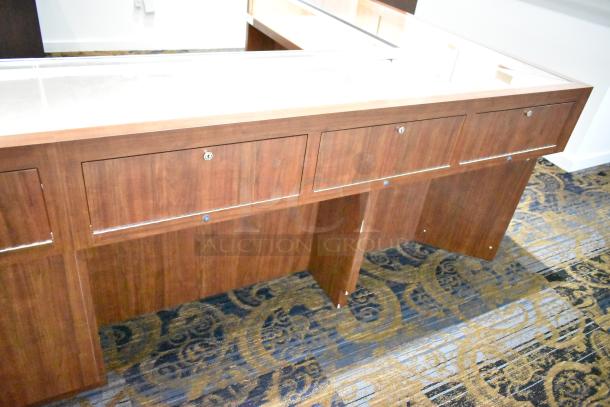 Lighted wooden jewelry display case with glass top, lockable drawers, and elegant wood finish, ideal for showcasing merchandise.