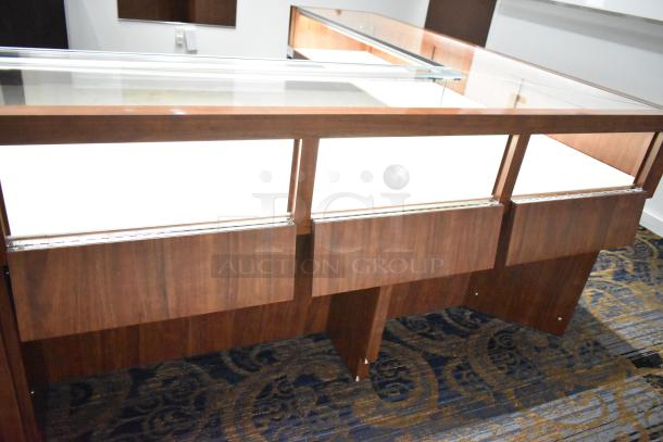 Lighted wooden jewelry display case with glass top, elegant finish, and dual storage compartments, in excellent condition.